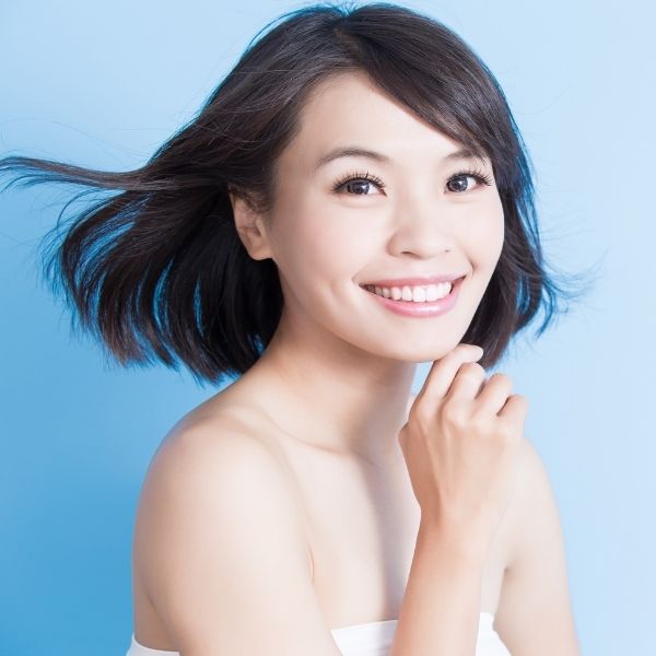 Woman poses for a photo after jaw feminization